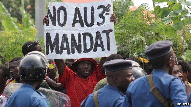 A protester holds a placard as they demonstrate against the ruling CNDD-FDD party's decision to allow Burundi President Pierre Nkurunziza to run for a third five-year term in office