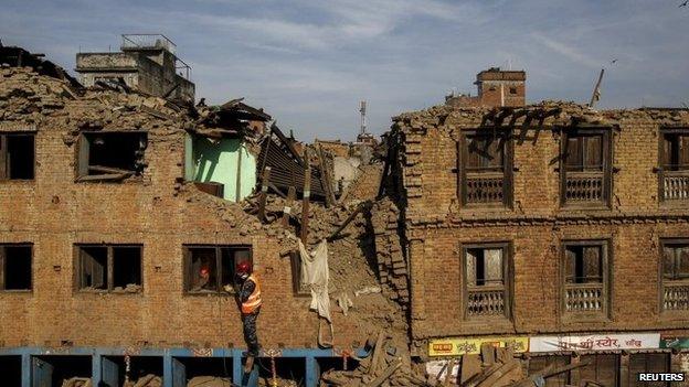 Nepalese military personnel climb up a collapsed house in Sankhu, on the outskirts of Kathmandu, Nepal, May 5, 2015