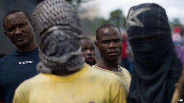 Protesters stand at a barricade in the Musaga neighbourhood of Bujumbura, Burundi, on May 5