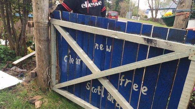 Gate in blue and white Scottish colours with the words: 'New Clear Free Scotland'