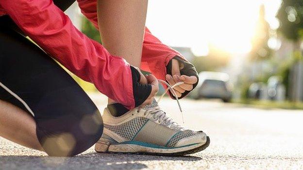 Female runner tying shoelaces