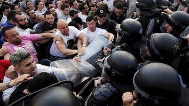 Protesters confront police outside government buildings in Skopje (5 May)