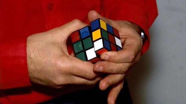 Man playing with Rubik's cube
