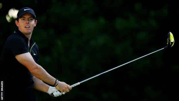 Rory McIlroy anxiously watches his tee shot on the 11th on Thursday