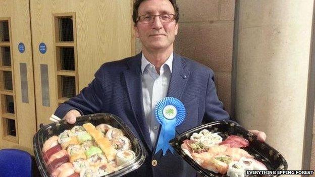 John Knapman holding trays of sushi