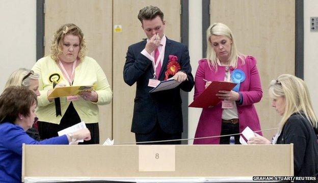 Counting agents supervise the count where Scottish Labour Party leader Jim Murphy is standing to be a member of parliament for East Renfrewshire