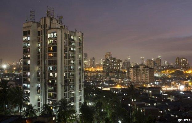 A high-rise residential tower is seen next to shanties in Dharavi, one of Asia"s largest slums, in Mumbai March 18, 2015. In Mumbai, the windows of new high-rise apartment blocks, old low-rise residential buildings and shantytown shacks portray the disparity in living conditions and incomes in the Indian city.