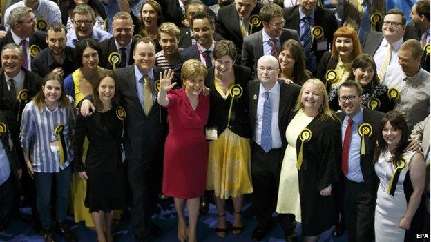 Scottish National Party (SNP) leader Nicola Sturgeon (C-L) celebrates with the seven new MPs for Glasgow