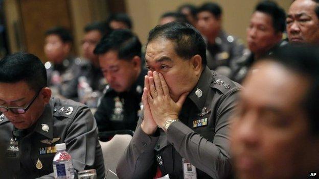 Thai policemen listen to Thai Police chief Gen Somyot Poompanmoung during a meeting about human trafficking at the police headquarters in Bangkok, Thailand , Friday, May 8, 2015.