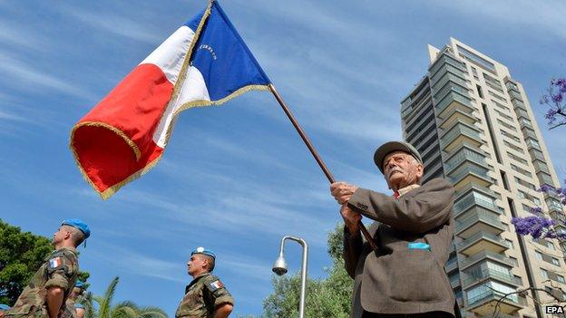 Lebanese Kamal Abed al-Nour holds a French flag in Beirut on 8 May 2015