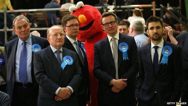 Tory supporters with a giant "Elmo" behind them