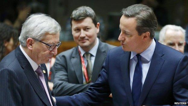 European Commission President Jean-Claude Juncker listens to Britain's Prime Minister David Cameron