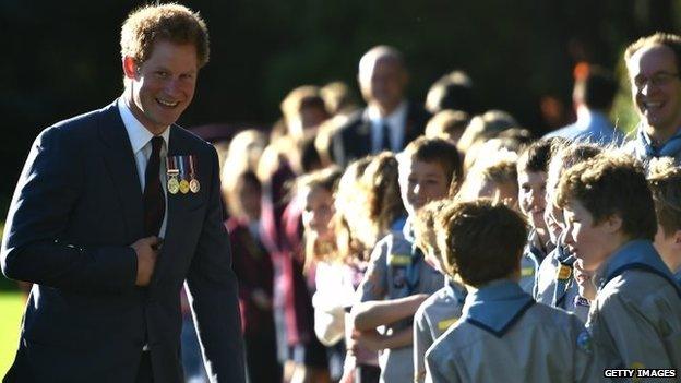 Prince Harry meets local school children during a welcome ceremony at Government House