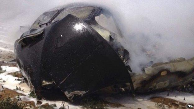 A handout picture released by National Police shows part of a Airbus A400 military plane which crashed in the San Pablo airport in Seville, southern Spain on 9 May 2015.