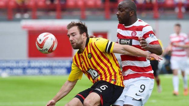 Partick Thistle's Conrad Balatoni (left) holds off Jason Scotland