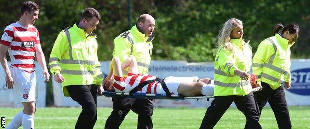 Hamilton Academical defender Mikey Devlin is stretchered off the field