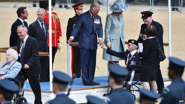 Prince Charles and the Duchess of Cornwall greet veterans