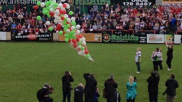 Balloons are released at the ground