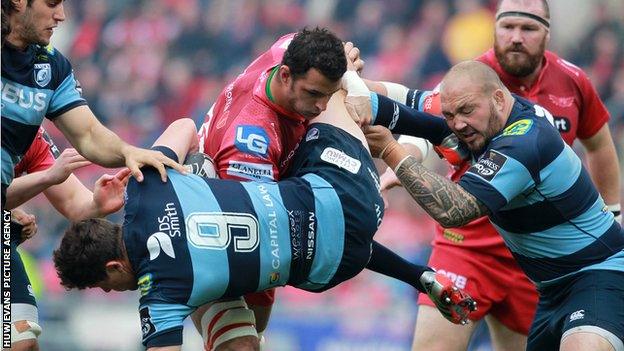 Scarlets back-row Aaron Shingler tackles Lloyd Williams of Cardiff Blues