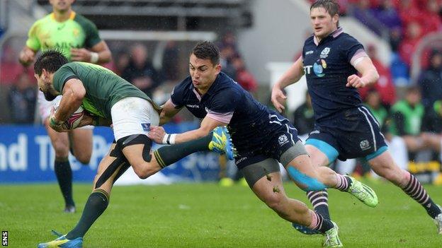 South Africa's Stephan Dippenaar is tackled by Damien Hoyland of Scotland