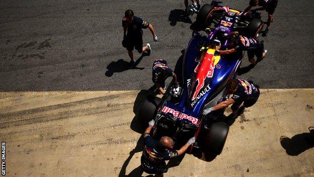 Daniel Ricciardo's Red Bull is inspected by the Red Bull engineers