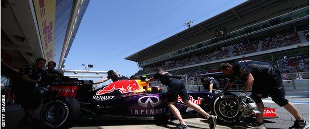 Red Bull engineers push Daniil Kvyat car back in to the garage