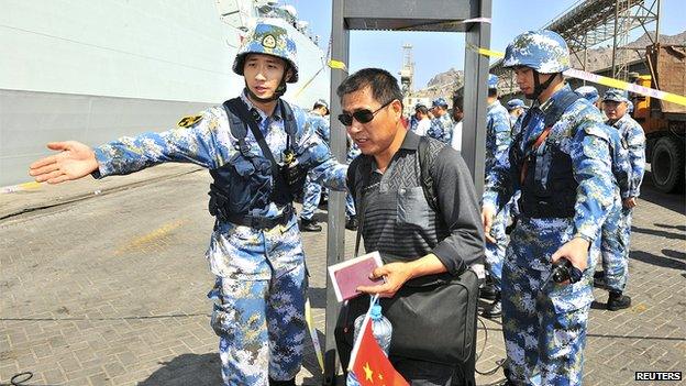 Chinese navy soldiers of the People's Liberation Army (PLA) help Chinese citizens board the naval ship Linyi at a port in Aden on 29 March 2015