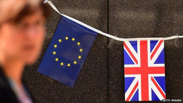 An European flag and a British flag stand next to each others outside the European Commission building in Brussels