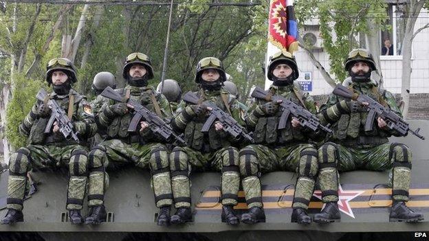 Pro-Russian rebels ride an armoured personal carrier (APC) during the military parade in downtown Donetsk, Ukraine, 9 May 2015