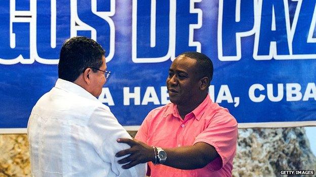 Farc commander Pablo Catatumbo (left) shakes hands with victim of Bojaya massacre Leyner Palacios at the Convention Palace of Havana on 18 December, 2014.