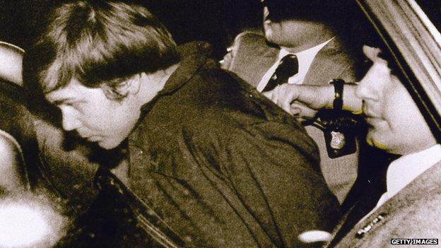 After trying to kill President Reagan, John W Hinckley Jr was taken away by authorities