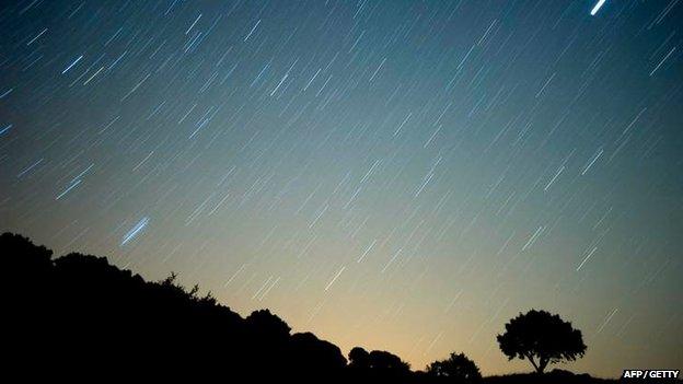 Meteor streaks across the sky against a field of star