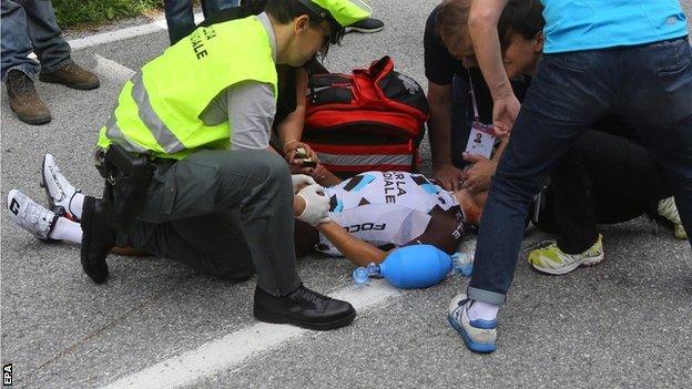 Italian rider Domenico Pozzovivo receives medical treatment after his fall during the third stage of the 98th Giro d"Italia