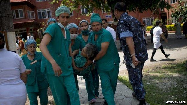 Medics treat an injured person at Police Hospital in Kathmandu following a further major earthquake on May 12, 2015 in Kathmandu, Nepal.