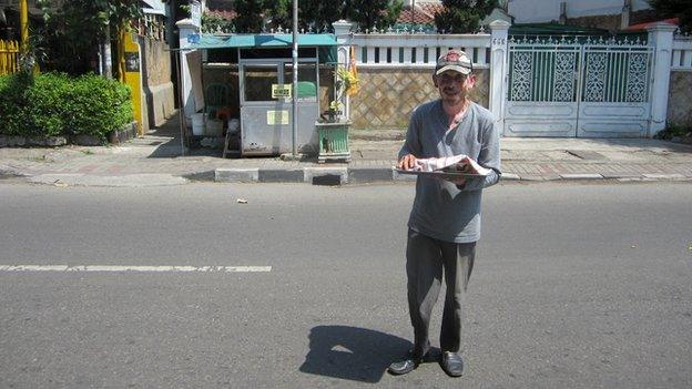 Purnomo in front of his noodle stall