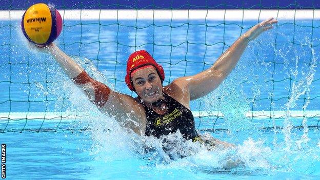 Woman waterpolo player saving a goal