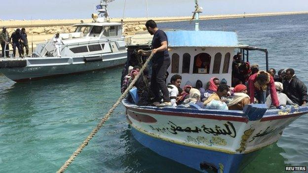 Illegal migrants who attempted to sail to Europe sit in a boat returning them to Libya as it is docked - 6 May 2015