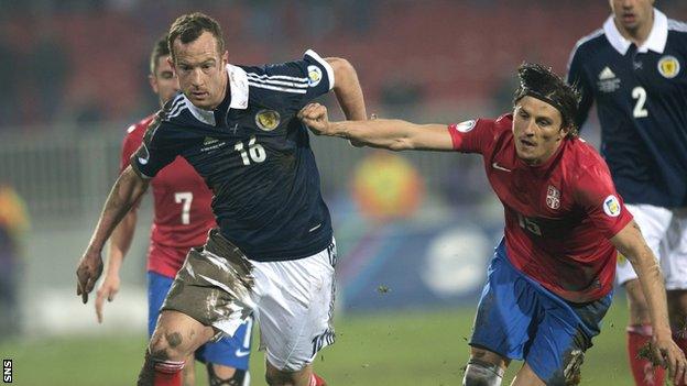 Charlie Adam battles with Serbia's Ljubomir Fejsa