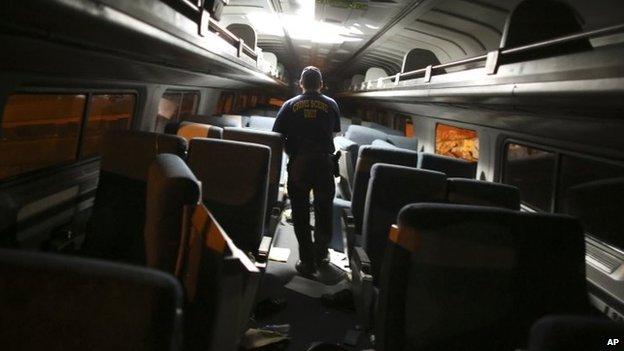 A crime scene investigator checks inside one of the carriages. Photo: 12 May 2015