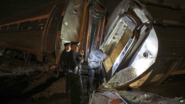 Emergency personnel work the scene of a train wreck, Tuesday, May 12, 2015, in Philadelphia.