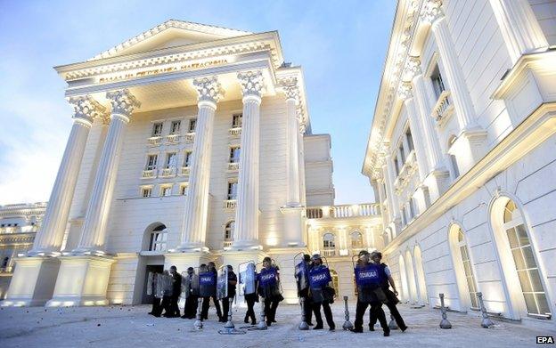 Police officers secure the government building during an anti-government protest in Macedonia on 5 May 2015