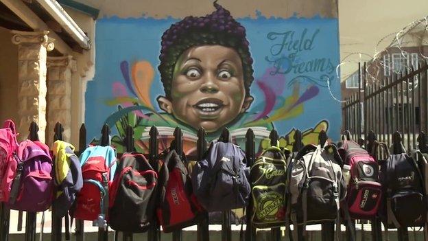 Rucksacks hanging on a fence