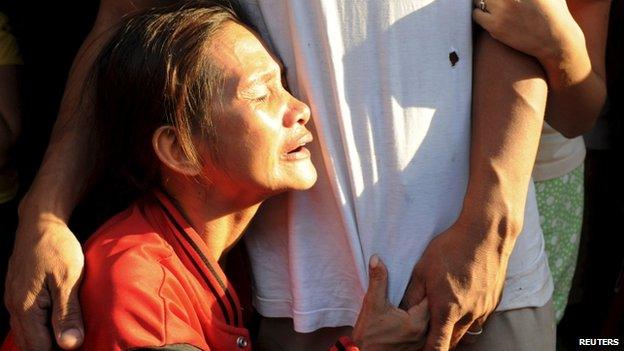 A woman weeps as she waits for her missing relative trapped in a fire at a factory in Valenzuela, Metro Manila in the Philippines May 13, 2015