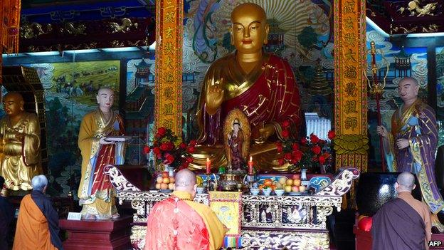 This photo taken on 13 April 2013 shows monks in the Xingjiao Temple in Xian, central China's Shaanxi province.