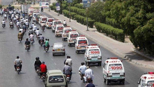 Ambulances carry the bodies of the victims of Wednesday's attack for burial