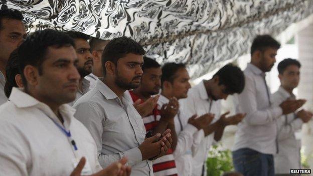 Mourners pray for the victims