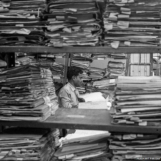An official amid stacks of files at Patna High Court