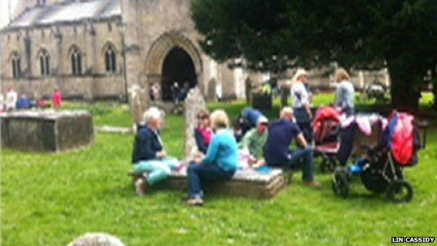 Picture of people picnicking on gravestones