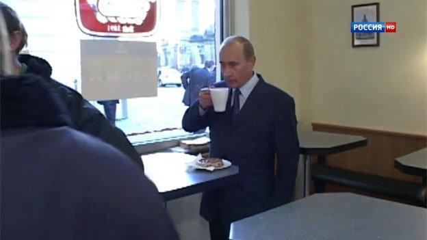 President Putin is shown drinking coffee with locals in a Dresden cafe in 2006