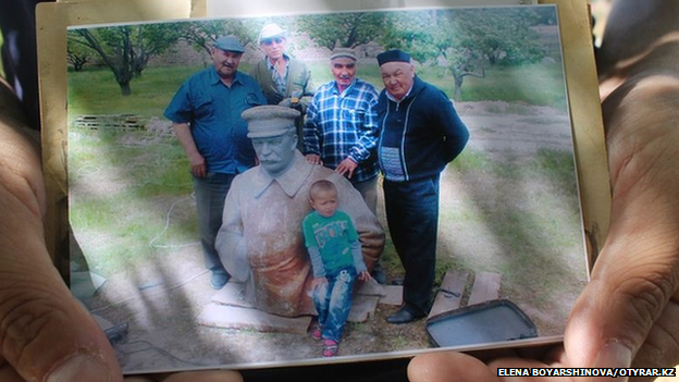 Villagers gathering around the Stalin statue